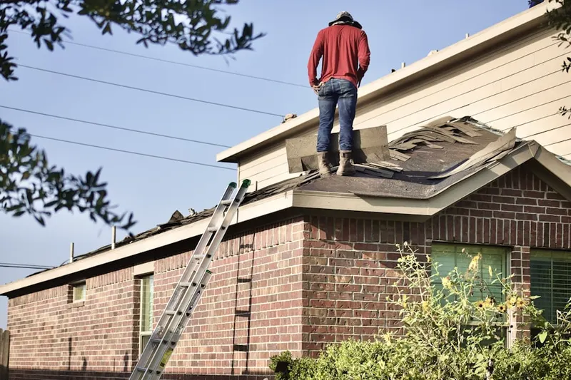 Professional roofer working on a residential roof in Sylvan Beach